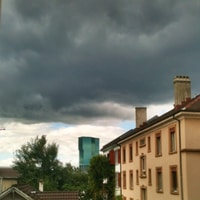 Black and white clouds and a skyscraper